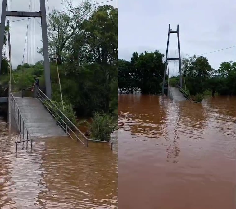La extraordinaria crecida del río Paraná inundó el emblemático puente colgante sobre el arroyo Jaguarazapá y encendió las alarmas en el sector turístico de Capitán Meza. Foto: Captura de video