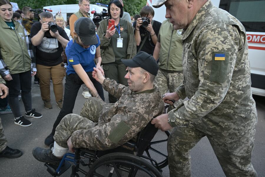 Un prisionero de guerra ucraniano liberado es empujado en una silla de ruedas a su llegada después de un intercambio de prisioneros en la región de Chernigiv, en medio de la invasión rusa de Ucrania. Foto: AFP