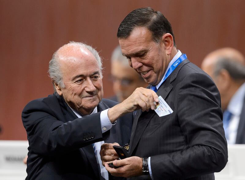 (FILES) This file photo taken on May 29, 2015 shows 
FIFA President Sepp Blatter (L) giving the Executive card member to South American Football Confederation (CONMEBOL) president Juan Angel Napout during the 65th FIFA Congress on May 29, 2015 in Zurich. 
The two FIFA officials detained in Zurich on December 3, 2015 on suspicion of corruption are vice presidents Juan Angel Napout of Paraguay and Alfredo Hawit of Honduras, a senior FIFA official said. / AFP / FABRICE COFFRINI