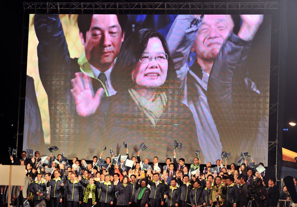 
Taiwan's President-elect Tsai Ing-wen (C), from the Democratic Progressive Party (DPP), is shown on a screen as she celebrates her victory alongside party officials after winning the elections inTaipei on January 15, 2016.  Voters in Taiwan elected a Beijing-sceptic president in a dramatic democratic journey, carving their own political path against China's wishes. AFP PHOTO / Sam Yeh / AFP / SAM YEH