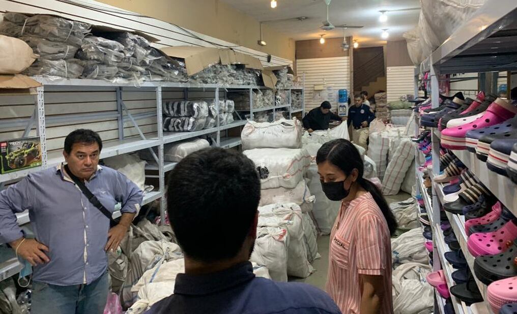 Funcionarios encabezaron la intervención al local donde se vendían calzados presuntamente falsificados. Foto: Dinapi.