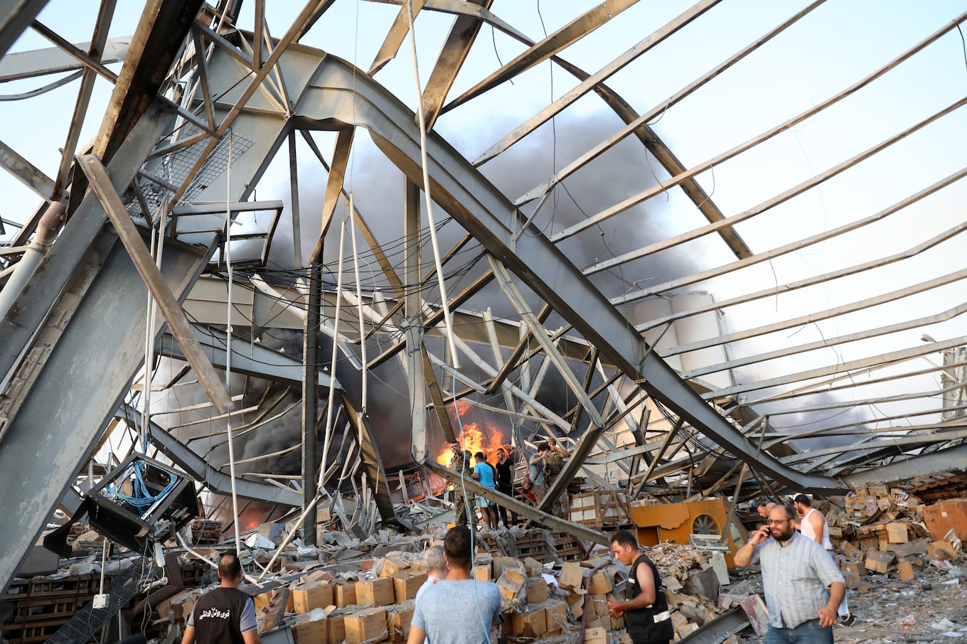 EDITORS NOTE: Graphic content / A picture shows the scene of an explosion at the port in Beirut on August 4, 2020. - Two huge explosion rocked the Lebanese capital Beirut, wounding dozens of people, shaking buildings and sending huge plumes of smoke billowing into the sky. Lebanese media carried images of people trapped under rubble, some bloodied, after the massive explosions, the cause of which was not immediately known. (Photo by ANWAR AMRO / AFP)