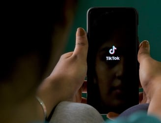An Indian mobile user browses through the Chinese owned video-sharing 'Tik Tok' app on a smartphone in Bangalore on June 30, 2020. - TikTok on June 30 denied sharing information on Indian users with the Chinese government, after New Delhi banned the wildly popular app citing national security and privacy concerns.
“TikTok continues to comply with all data privacy and security requirements under Indian law and have not shared any information of our users in India with any foreign government, including the Chinese Government,” said the company, which is owned by China's ByteDance. (Photo by Manjunath Kiran / AFP)