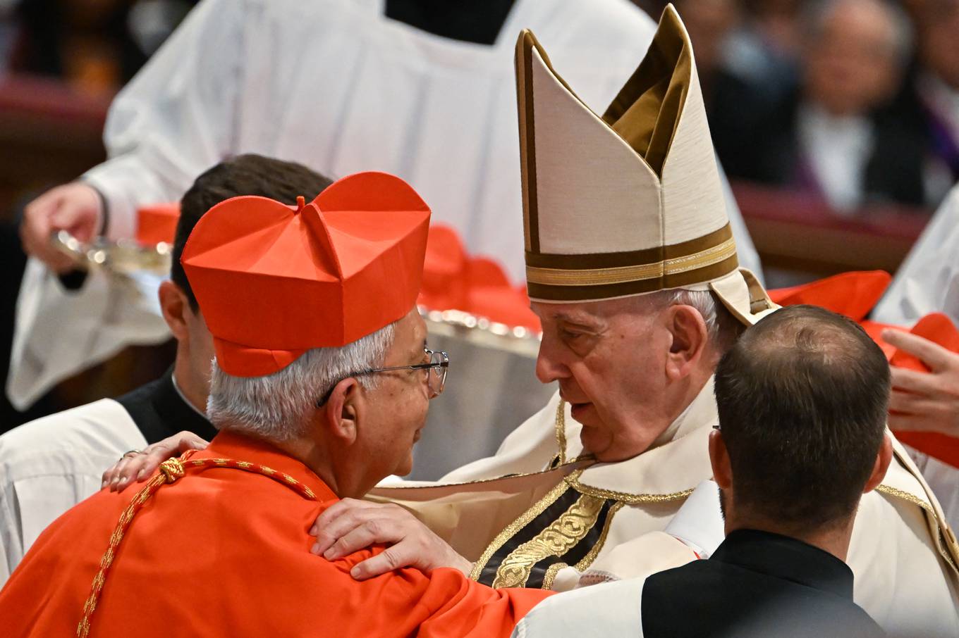 Pope Francis speaks to Monsignor Adalberto Martinez Flores (L) after he elevated him to Cardinal during a consistory to create 20 new cardinals, on August 27, 2022 at St. Peter's Basilica in The Vatican. (Photo by Alberto PIZZOLI / AFP)