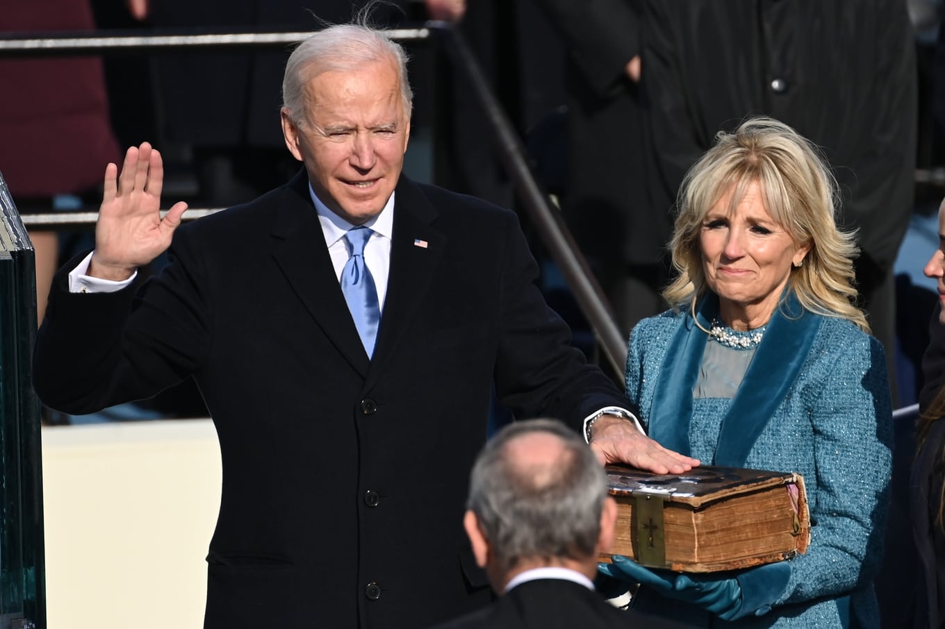 Joe Biden (L), flanked by incoming US First Lady Jill Biden is sworn in as the 46th US President by Supreme Court Chief Justice John Roberts on January 20, 2021, at the US Capitol in Washington, DC. (Photo by SAUL LOEB / POOL / AFP)